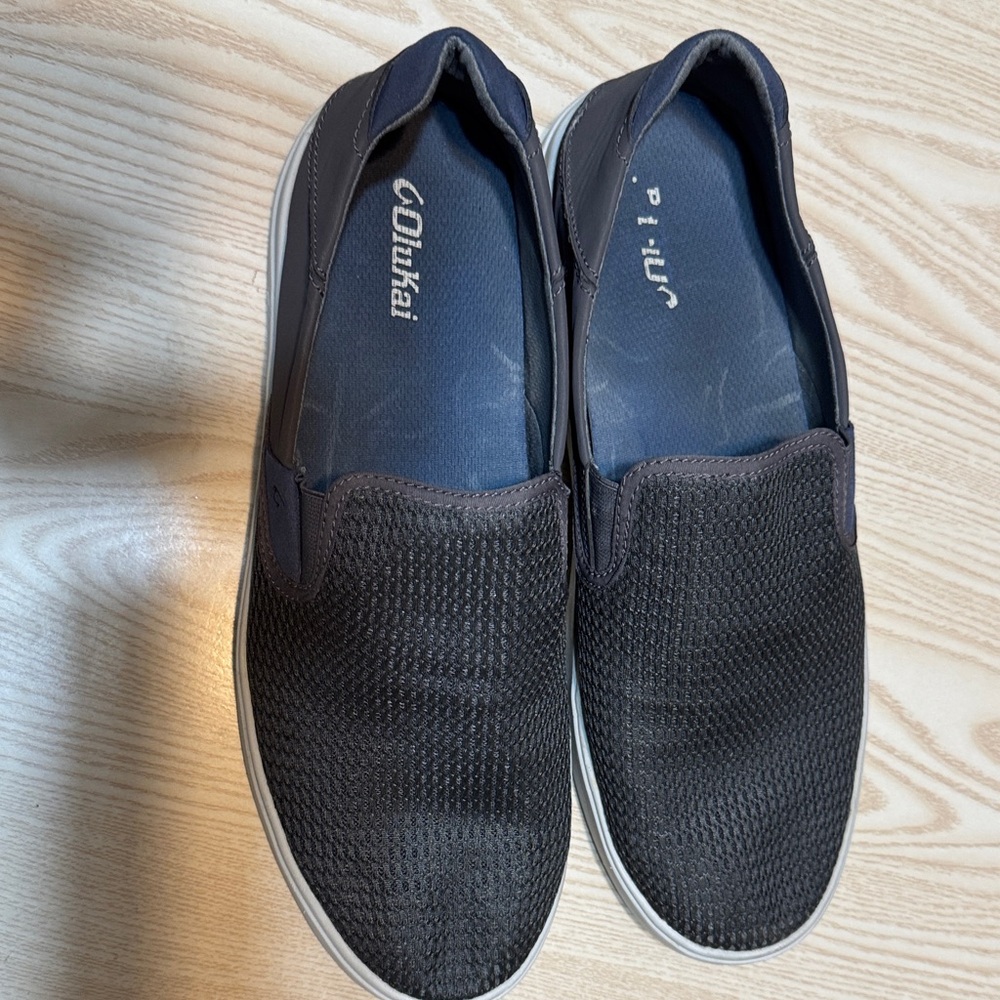 OluKai Men's Black Mesh Slip-Ons- DARK GREY in color